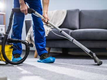 Person-cleaning-carpet-with-vacuum-cleaner-picture-id1191080465
